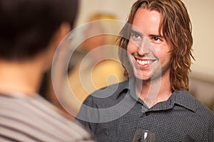 Smiling Young Man with Glass of Wine Socializing photo