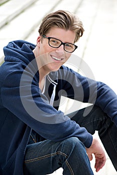 Smiling young man with glasses