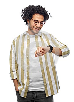 smiling young man in glasses with smart watch