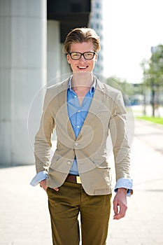 Smiling young man with glasses walking