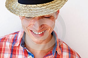 Smiling young man with hat against white background