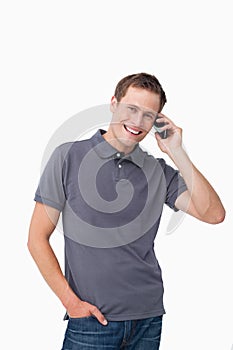 Smiling young man on his mobile phone