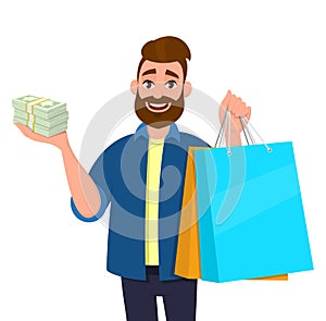 Smiling young man holding shopping bags. Person showing bunch of cash, money, currency notes in hand. Modern lifestyle, digital.