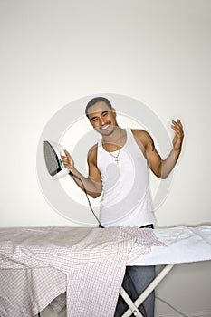 Smiling Young Man Ironing