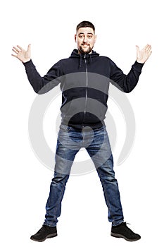 Smiling young man in jeans and a hoody is jumping. Full height. Isolated over white background.