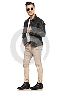 Smiling young man in leather jacket and sunglasses