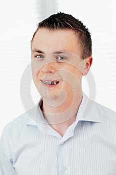 Smiling young man with orthodontic braces.