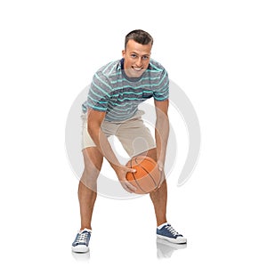 Smiling young man playing basketball