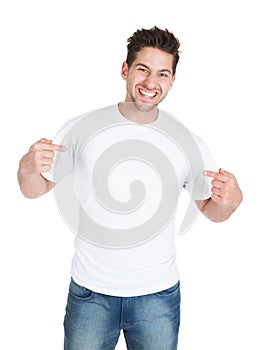 Smiling young man pointing itself photo