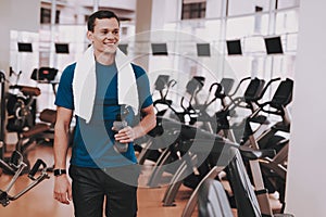 Smiling Young Man in Sport Club near Treadmills