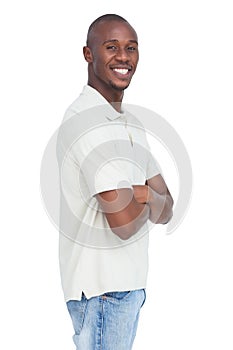 Smiling young man standing with arms crossed