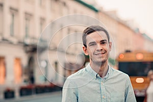 Smiling young man standing in the city