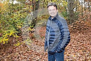 Smiling young man standing near the tree