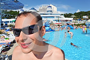 Smiling young man in sunglasses in aquapark