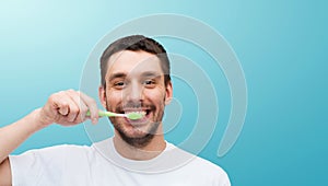 Smiling young man with toothbrush