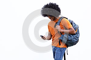 Smiling young man walking with bag and mobile phone