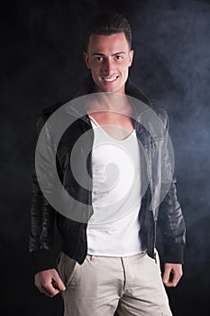 Smiling young man with white t-shirt and leather jacket