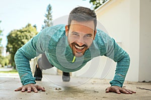 Smiling young man working pushbuttons. Front view.