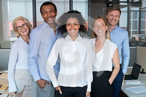 Smiling young african leader looking at camera with diverse team photo