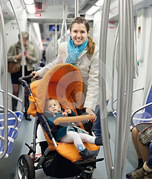 Smiling young mother with baby at metro