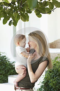 Smiling Young Mother And Baby