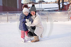 Smiling young mother and her cute little daughter