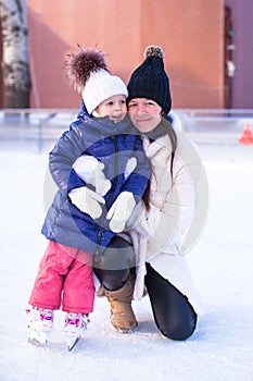 Smiling young mother and her cute little daughter