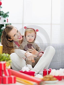 Smiling young mother spending Christmas with baby
