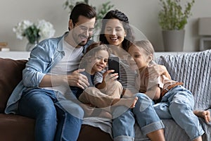 Happy family with kids use modern smartphone