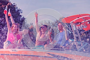 Smiling young people cruising in a modern yacht