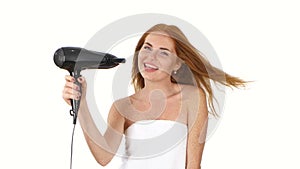 Smiling young Redhead girl singing while blow-dry