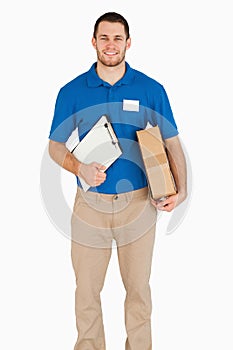 Smiling young salesman with packet and clipboard