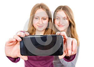 Smiling young sisters taking selfie