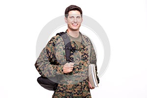 Smiling young soldier with documents and backpack