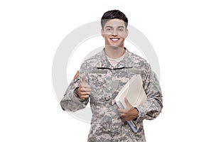 Smiling young soldier with documents gesturing thumbs up