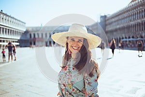 smiling woman in floral dress having walking tour photo