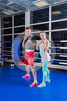 Smiling young sporty couple in sportswear training in regular bo