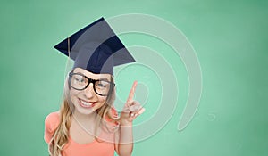 Smiling young student woman in mortarboard