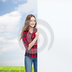 Smiling young teenage girl with white blank board
