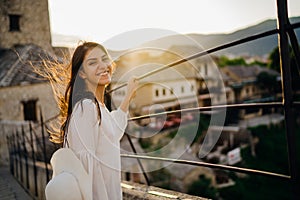 Smiling young tourist sightseeing the historic landmarks of old town in Mostar, Bosnia and Herzegovina. Visiting touristic