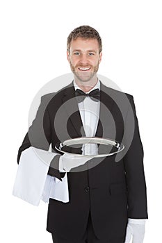 Smiling Young Waiter Holding Empty Serving Tray