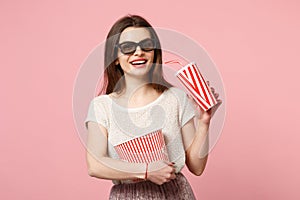 Smiling young woman in 3d imax glasses posing isolated on pastel pink background. People sincere emotions in cinema