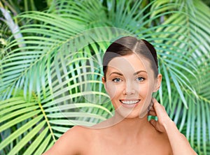 Smiling young woman with bare shoulders