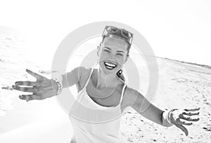 Smiling young woman on beach in evening having fun time