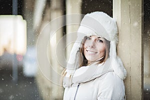 Smiling young woman in blizzard