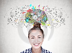 Smiling young woman with a bun, gear brain