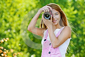 Smiling young woman with camera