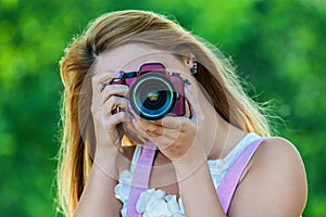 Smiling young woman with camera