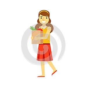 Smiling young woman carrying a brown shopping bag with healthy food. Shopping in grocery store, supermarket or retail