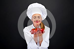 Smiling young woman chef with tomatos juggle